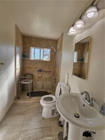 a spacious bathroom with a sink and a mirror