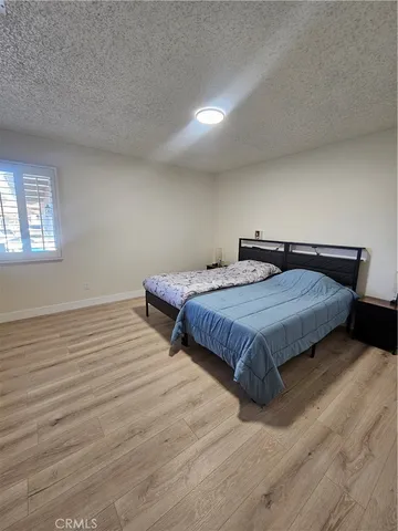 a bedroom with double bed and a wooden floor