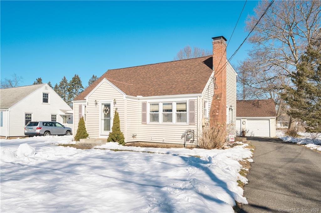 a view of a house with snow on the road