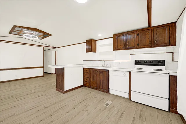 a kitchen with stainless steel appliances granite countertop a stove and cabinets