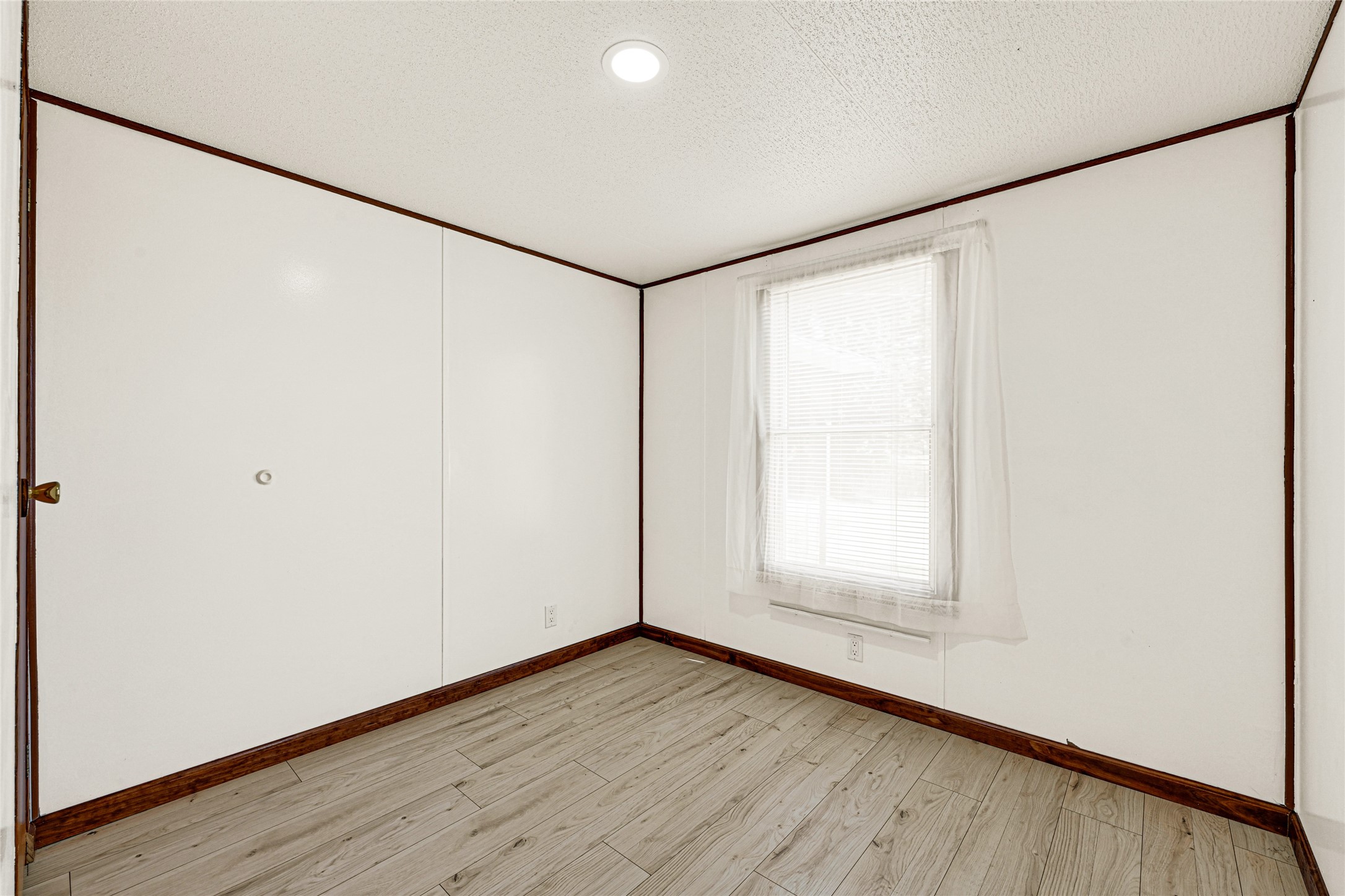 16794 Balmoral Street Montgomery, TX 77316 - Photo 15 of 24 a view of an empty room with wooden floor and a window
