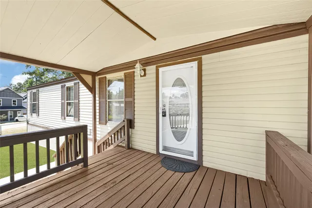 a view of a porch with wooden floor
