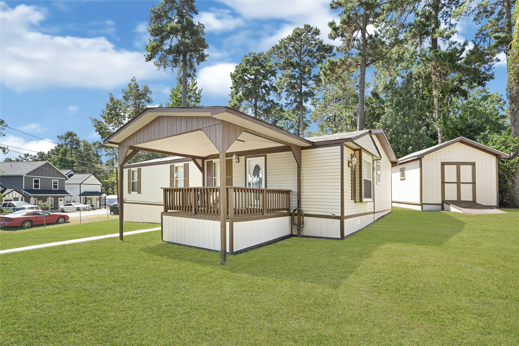 16794 Balmoral Street Montgomery, TX 77316 - Photo 6 of 24 a view of a white house with a yard and deck