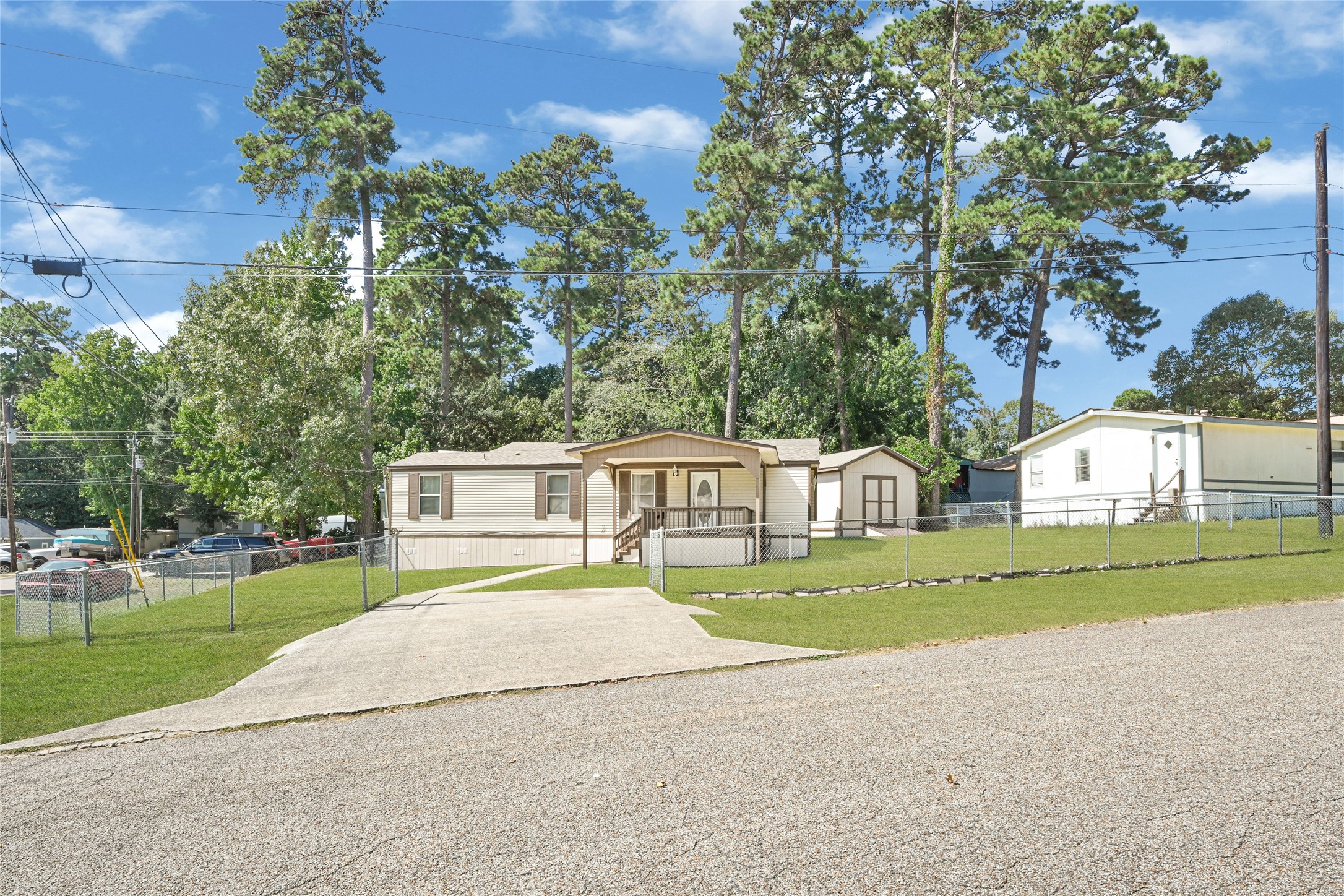 16794 Balmoral Street Montgomery, TX 77316 - Photo 7 of 24 a front view of a house with a yard and trees