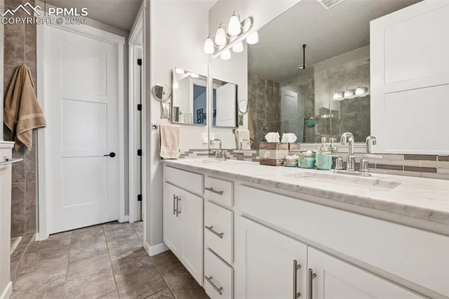 a bathroom with a double vanity sink and a mirror