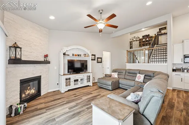 a living room with furniture a fireplace and a flat screen tv