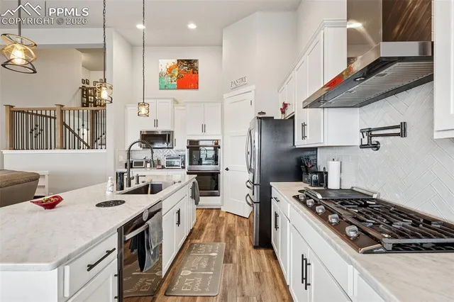 a kitchen with stainless steel appliances a sink dishwasher stove and refrigerator