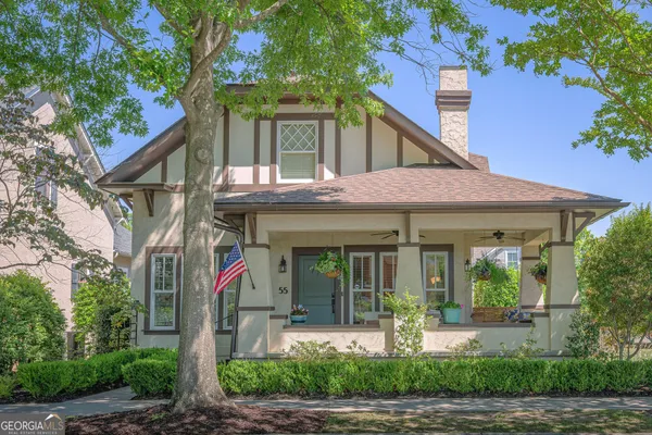 a front view of a house with garden and plants