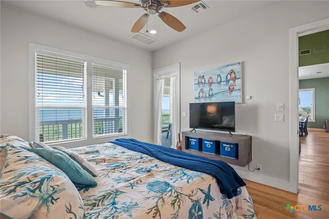a bedroom with a large bed and a flat screen tv