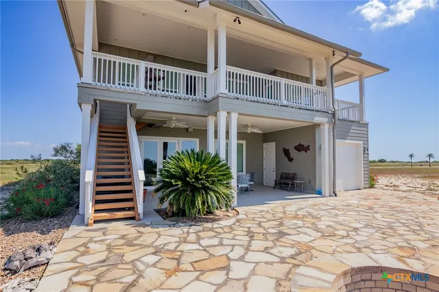 a view of an outdoor sitting area with furniture and garden view