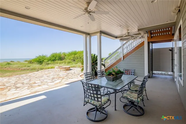 a view of a porch with chairs and backyard