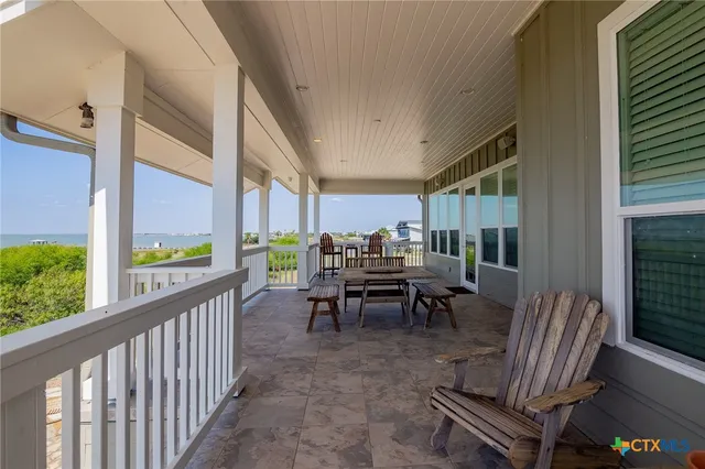 a view of a porch with furniture and front door
