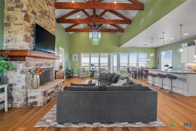 a living room with furniture a flat screen tv and a fireplace