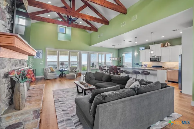 a living room with furniture kitchen and a table