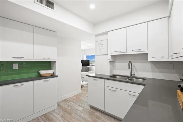 a kitchen with stainless steel appliances granite countertop a sink and cabinets