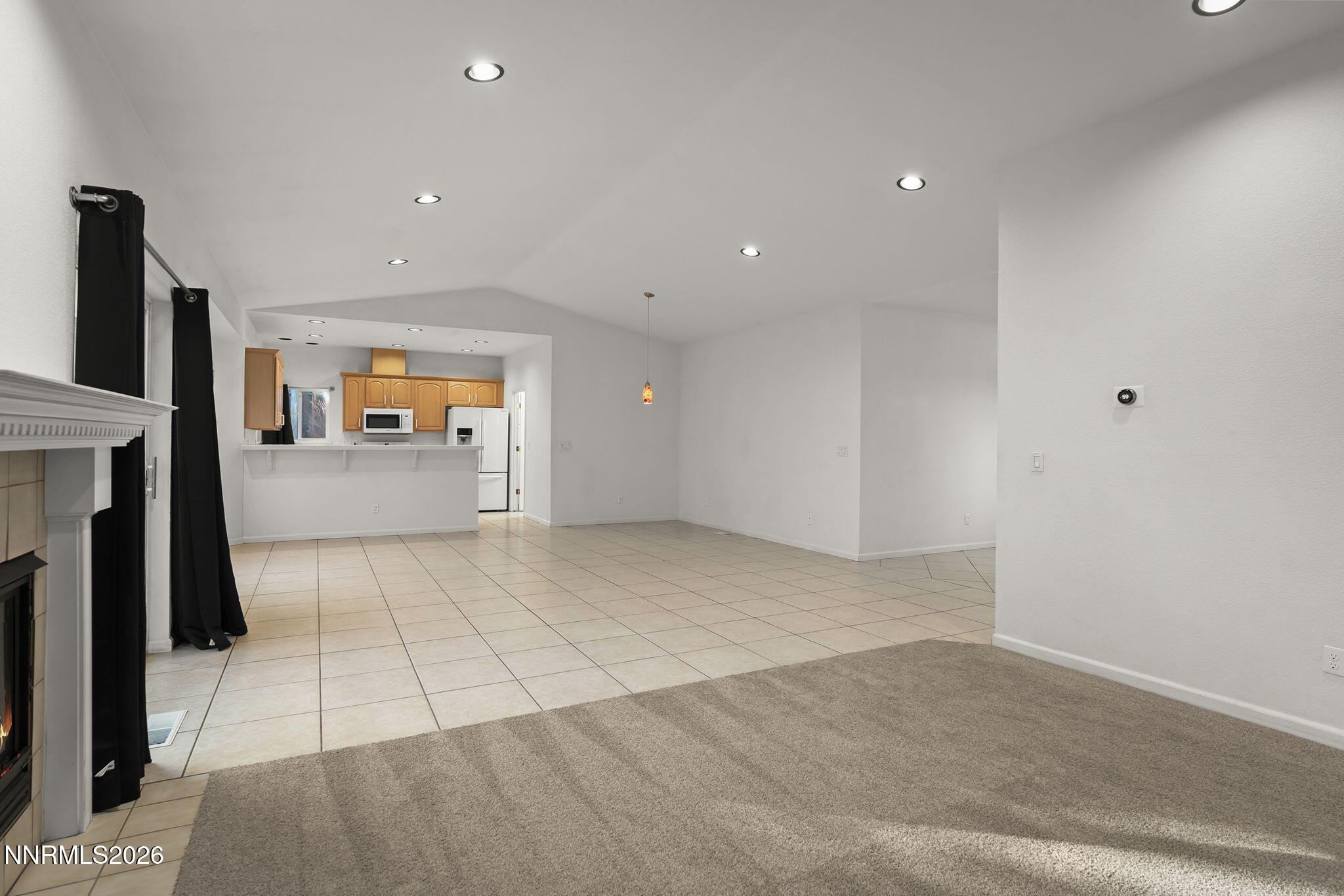 474 West Plumb Lane Reno, NV 89509 - Photo 4 of 35 an empty room with fireplace and natural light