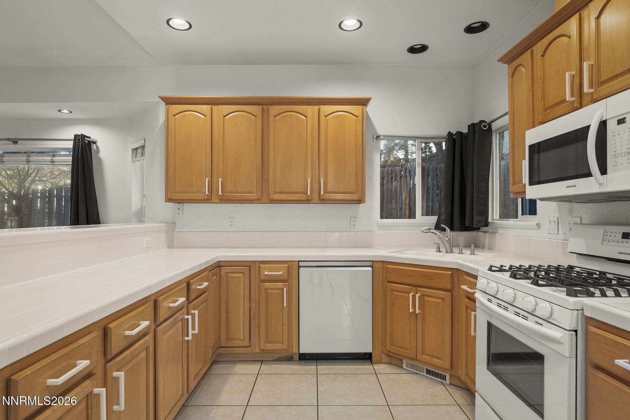 474 West Plumb Lane Reno, NV 89509 - Photo 7 of 35 a kitchen with granite countertop a sink stainless steel appliances and cabinets