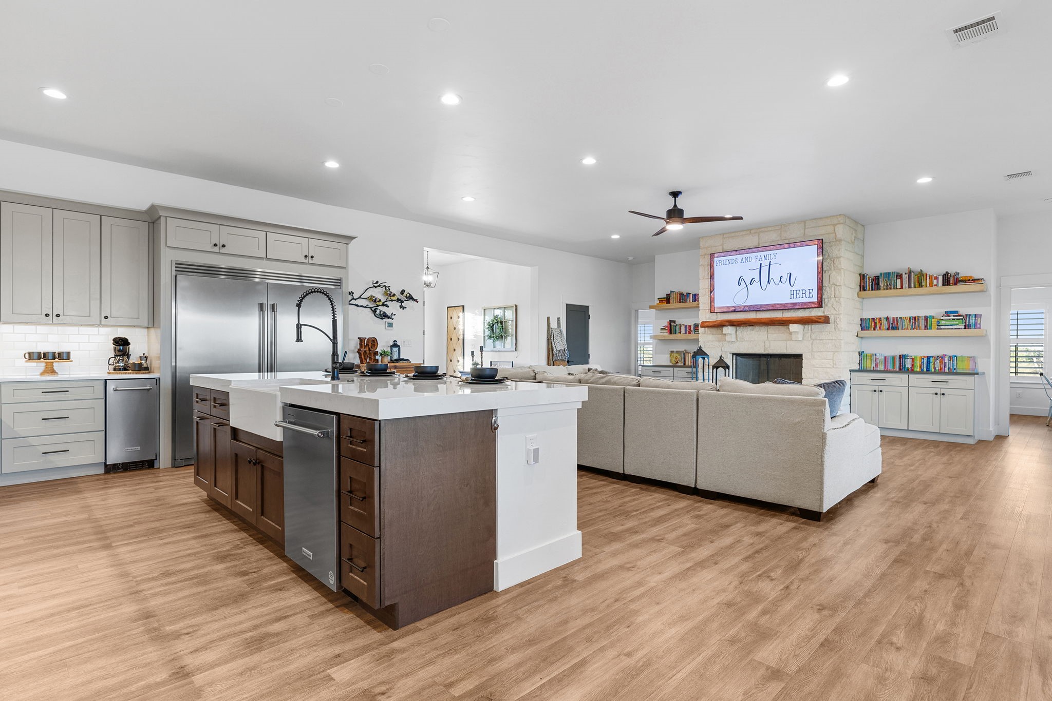 345 Judge's Road Burnet, TX 78611 - Photo 11 of 40 a kitchen with stainless steel appliances a stove top oven a sink dishwasher and a refrigerator with wooden floor