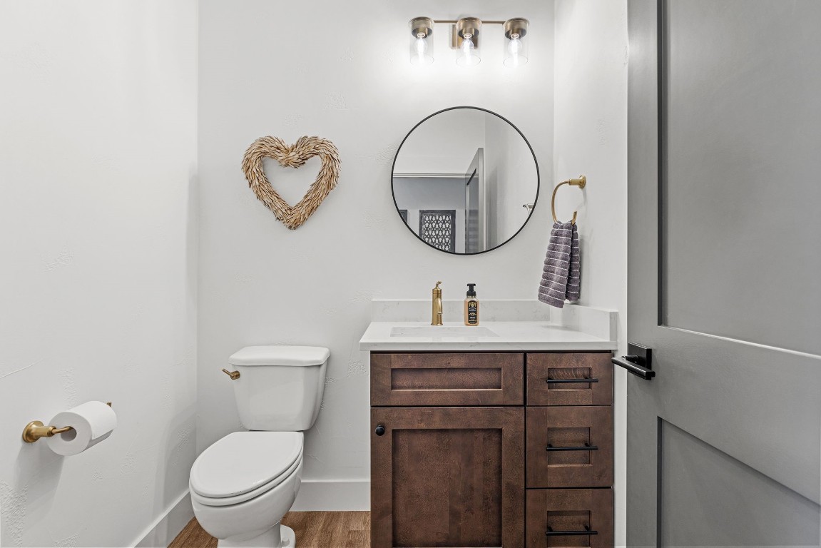 345 Judge's Road Burnet, TX 78611 - Photo 16 of 40 a bathroom with a toilet a sink and a mirror