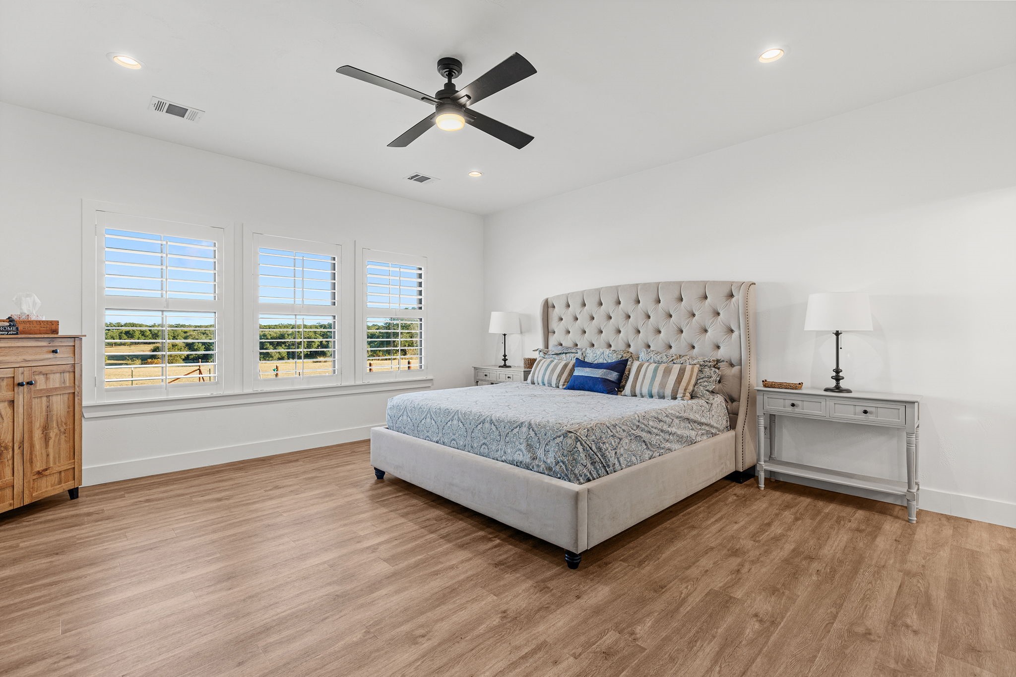 345 Judge's Road Burnet, TX 78611 - Photo 17 of 40 a spacious bedroom with a bed and large windows