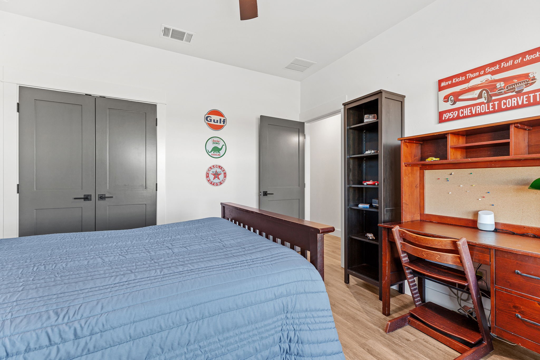 345 Judge's Road Burnet, TX 78611 - Photo 22 of 40 a bedroom with a bed and a bookshelf with wooden floor