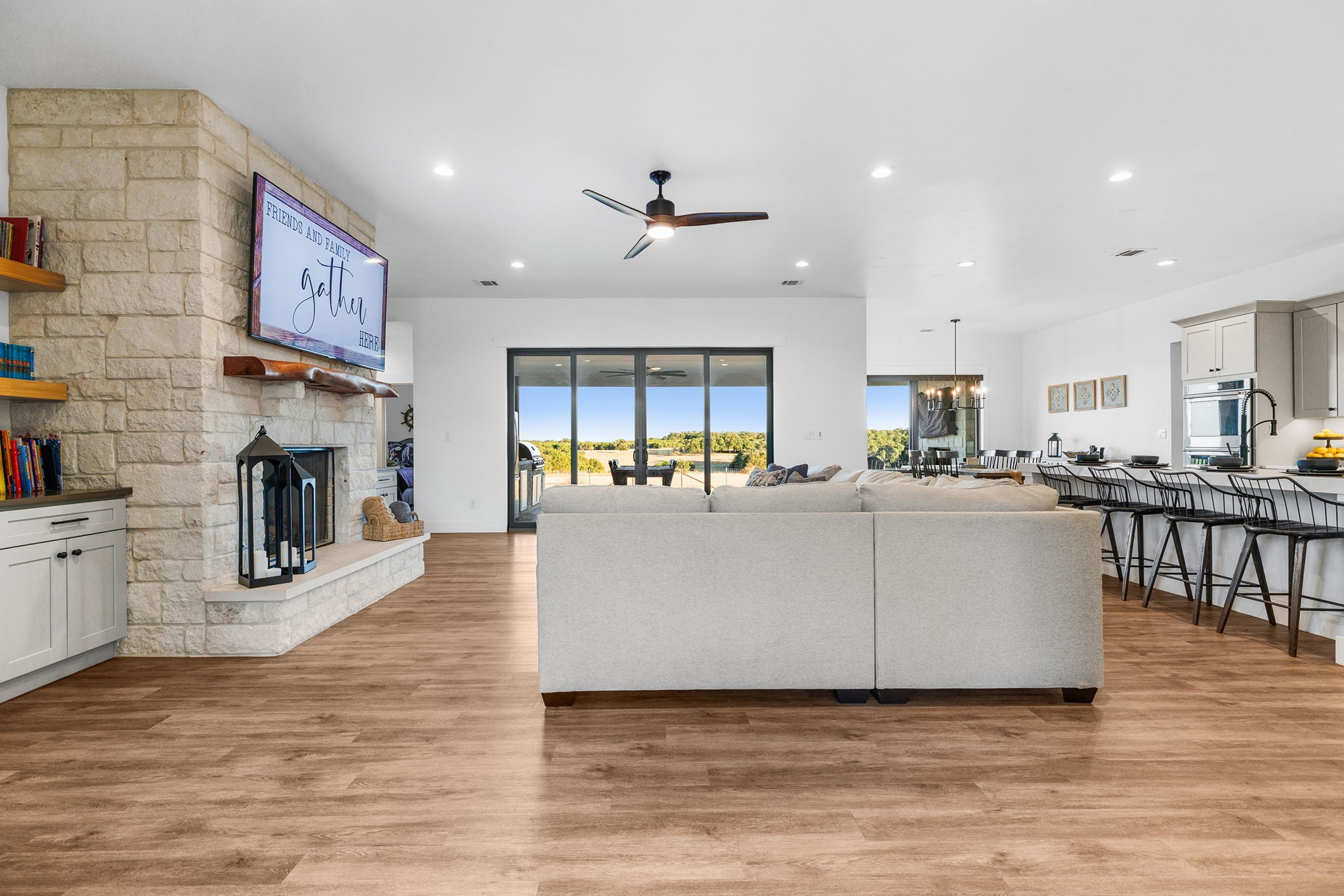 345 Judge's Road Burnet, TX 78611 - Photo 6 of 40 a living room with fireplace furniture and a kitchen view