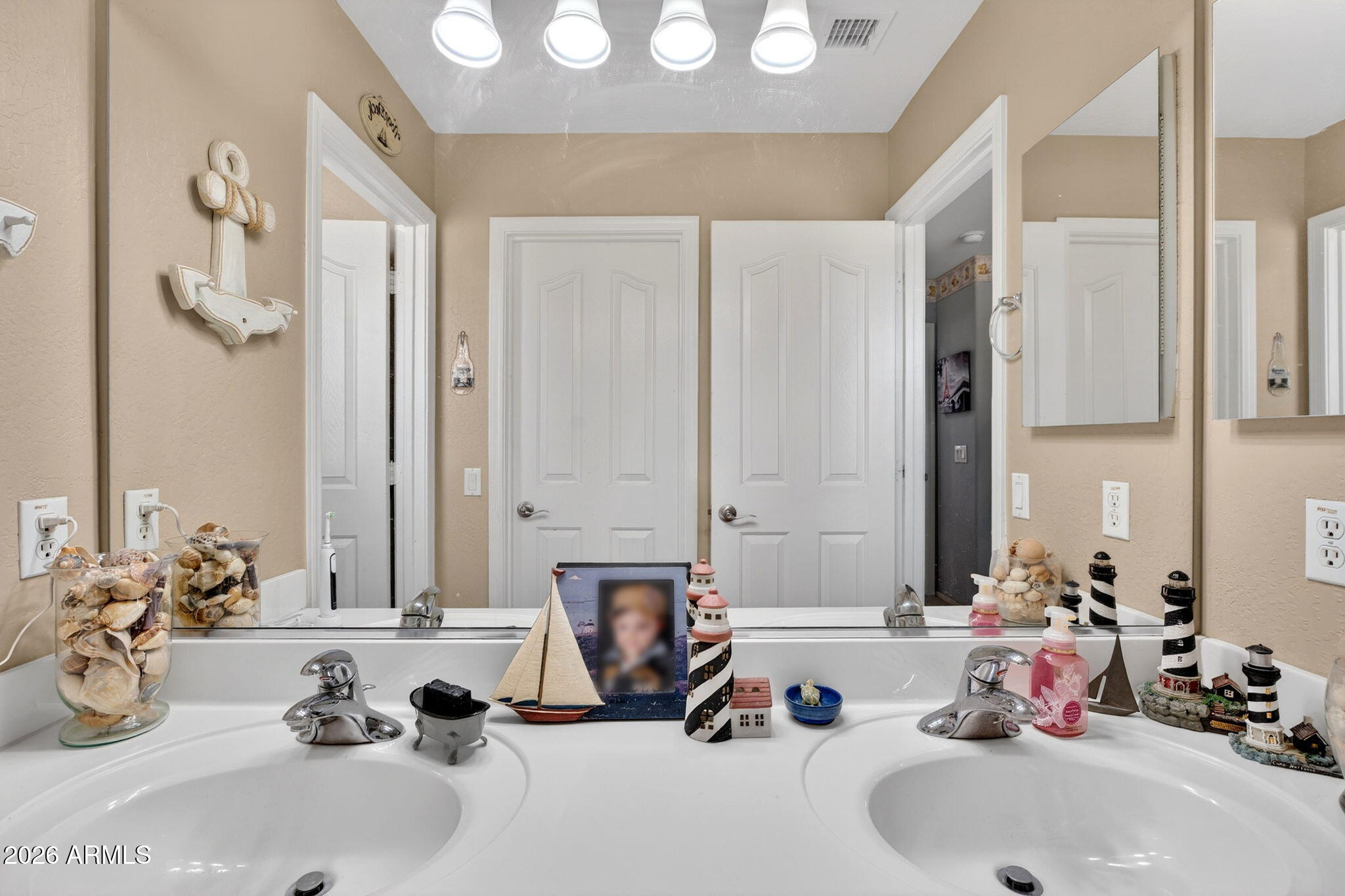 6280 South Sinova Court Gilbert, AZ 85298 - Photo 47 of 64 a bathroom with a double vanity sink and a mirror