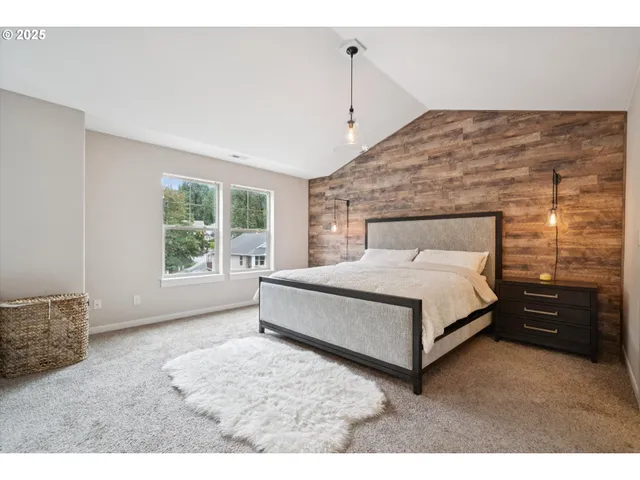 a spacious bedroom with a bed and a window