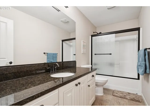 a bathroom with a granite countertop sink mirror and double