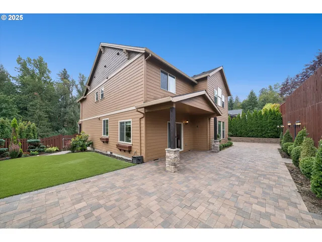 a view of a house with a yard and garage