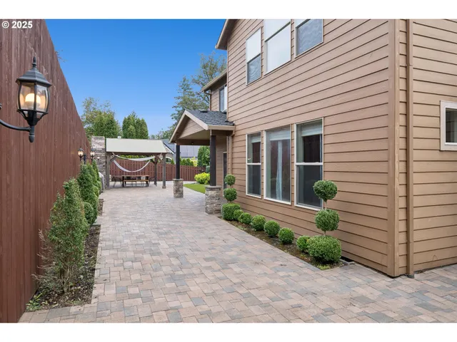 a view of a patio with table and chairs and potted plants