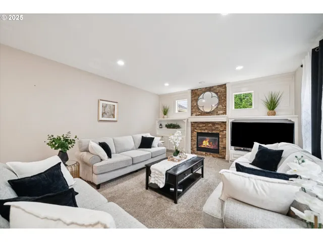 a living room with furniture and a fireplace