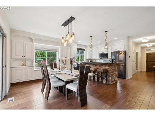 a dining room with furniture and wooden floor