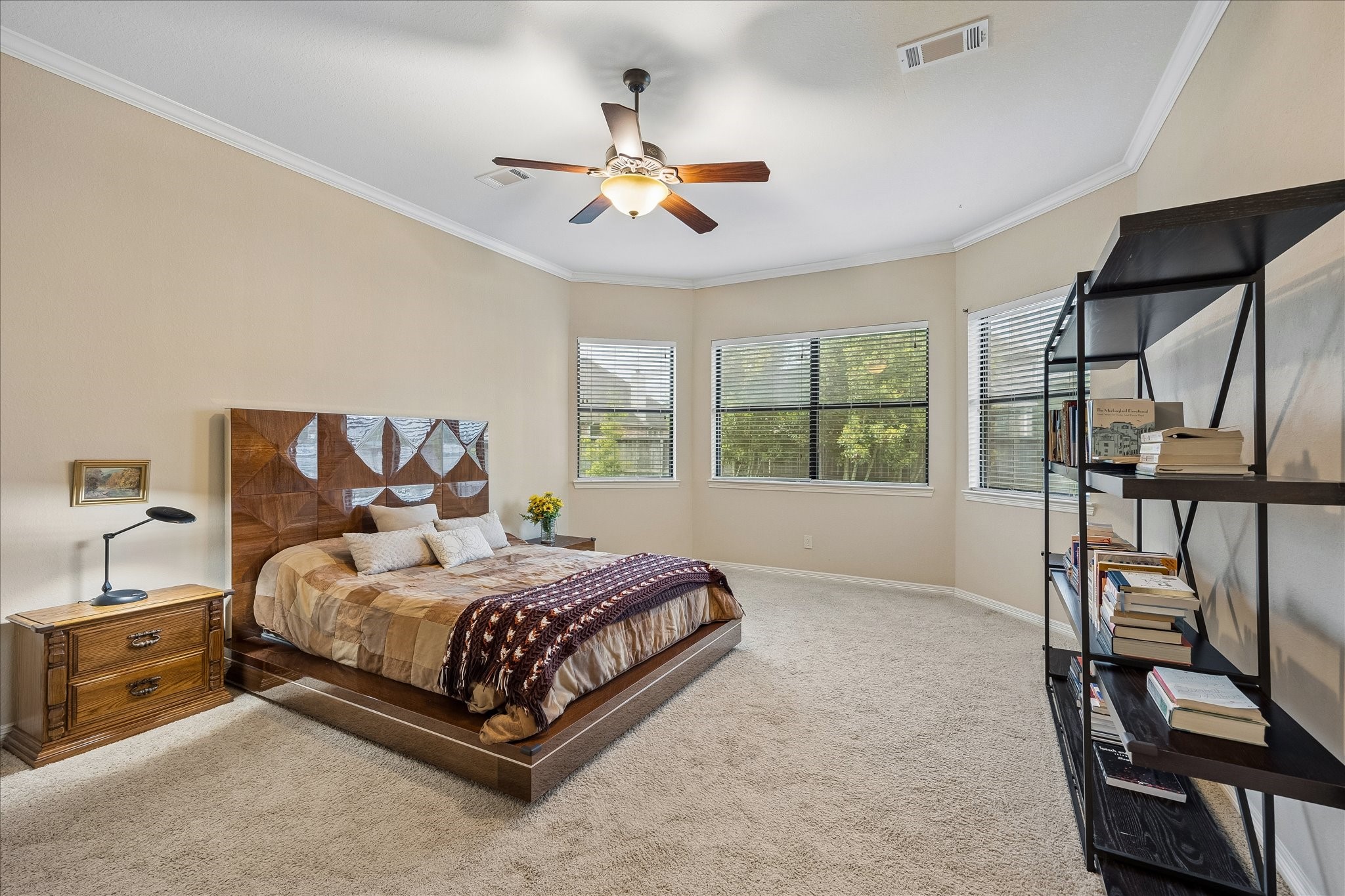622 West Fork Webster, TX 77598 - Photo 14 of 36 Large windows and a roomy layout give the primary bedroom an airy, comfortable feel. Notice the crown molding continues as well as a bay window