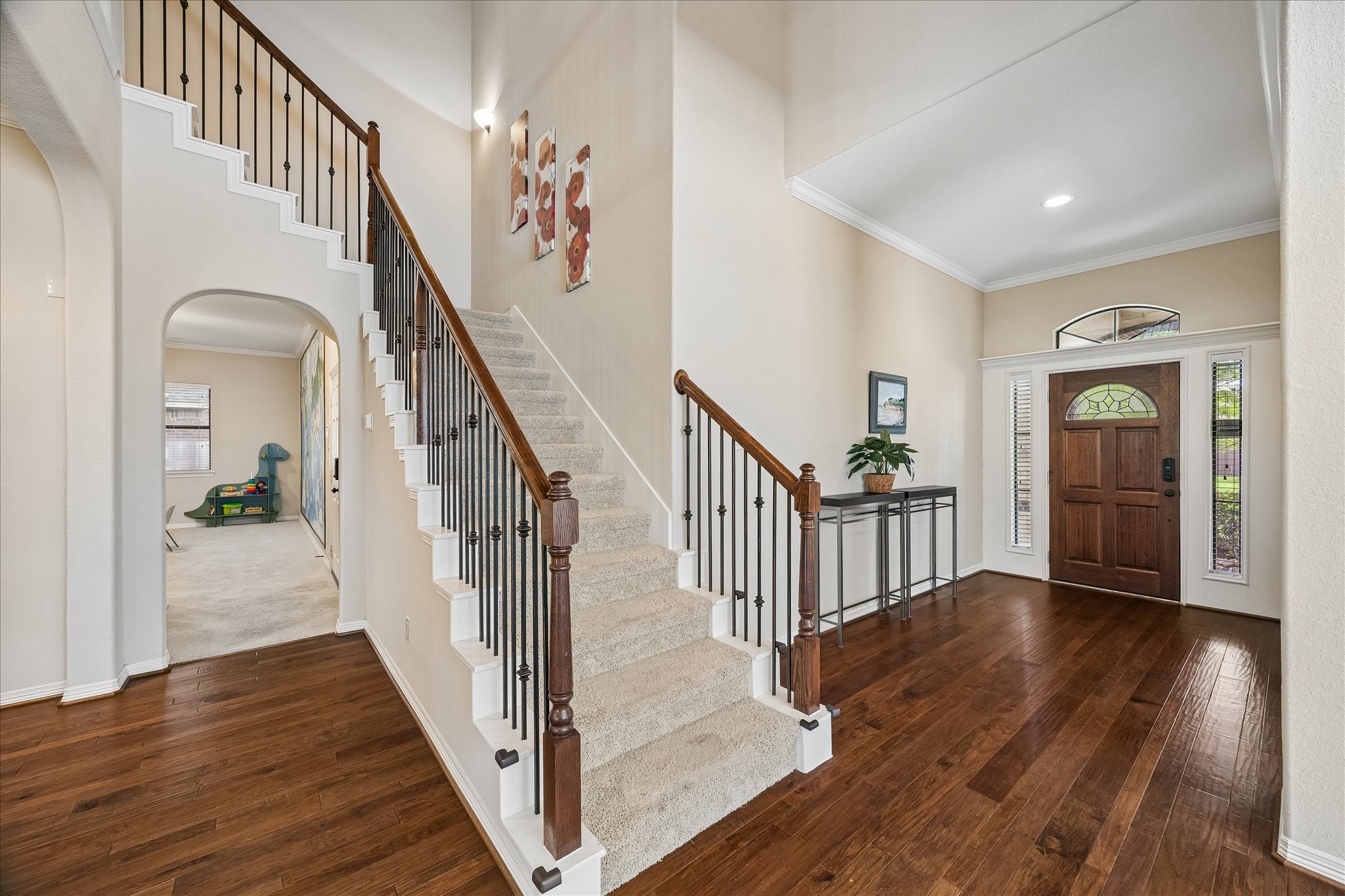 622 West Fork Webster, TX 77598 - Photo 2 of 36 Step inside to a bright entry with high ceilings, warm wood flooring, and an open feel from the start. Notice the wrought iron spindles on the staircase adding a touch of class