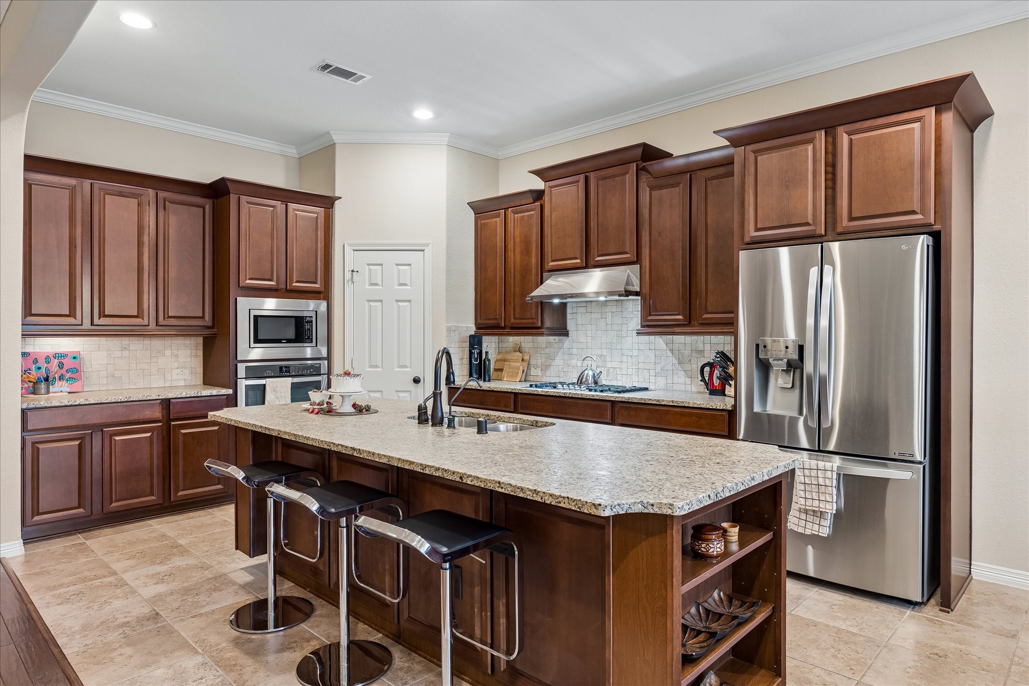 622 West Fork Webster, TX 77598 - Photo 4 of 36 Granite counters, gas cooking, and ample prep space support a kitchen designed to be used and enjoyed.