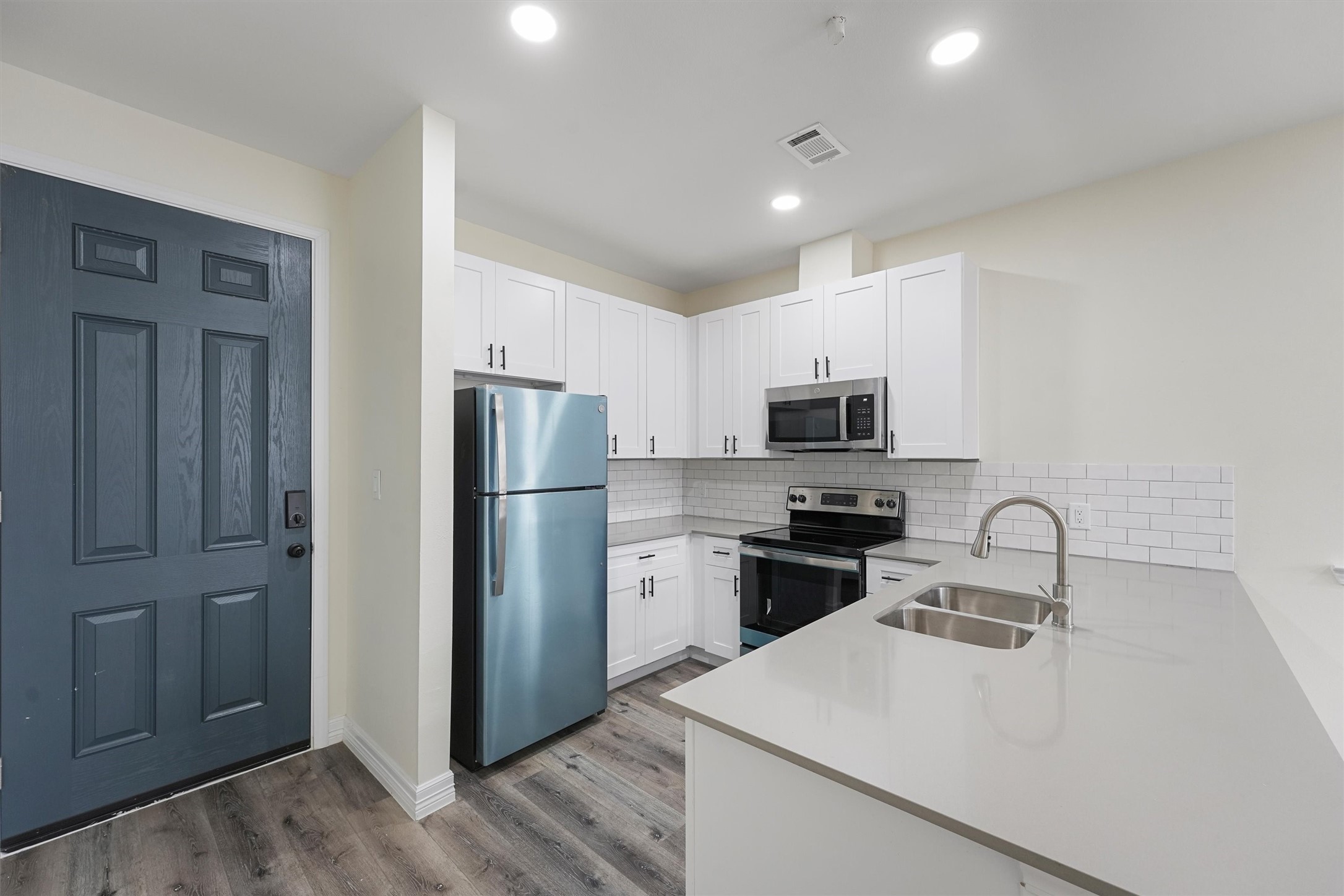 2130 Aldine Mail Rte Road, Unit B101 Houston, TX 77039 - Photo 2 of 9 a kitchen with stainless steel appliances granite countertop a refrigerator sink and stove