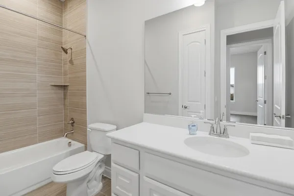 a bathroom with a sink toilet vanity and shower