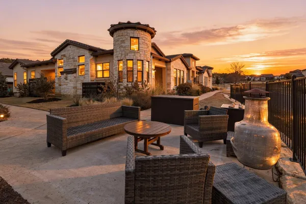 a front view of a house with a garden and sitting area