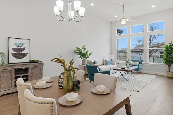 a view of a dining room with furniture a chandelier and wooden floor