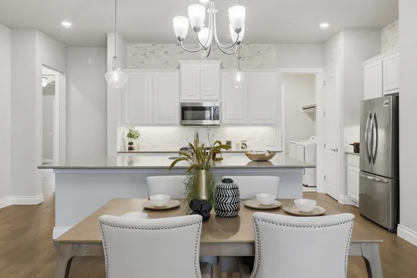 a kitchen with stainless steel appliances granite countertop a sink a refrigerator and a refrigerator