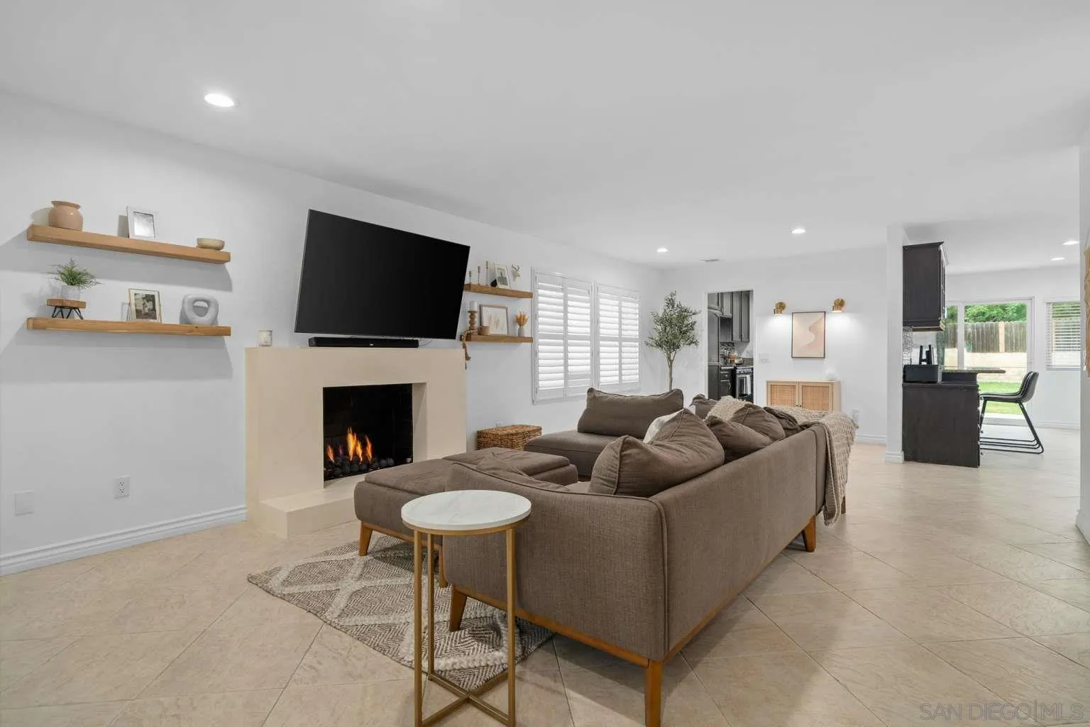 9026 Hamilton Street Rancho Cucamonga, CA 91701 - Photo 5 of 26 a living room with furniture a fireplace and a flat screen tv