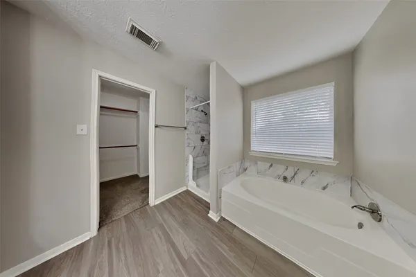 a bathroom with a bathtub and a sink