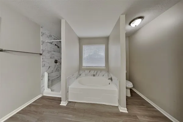 a bathroom with a bathtub and shower