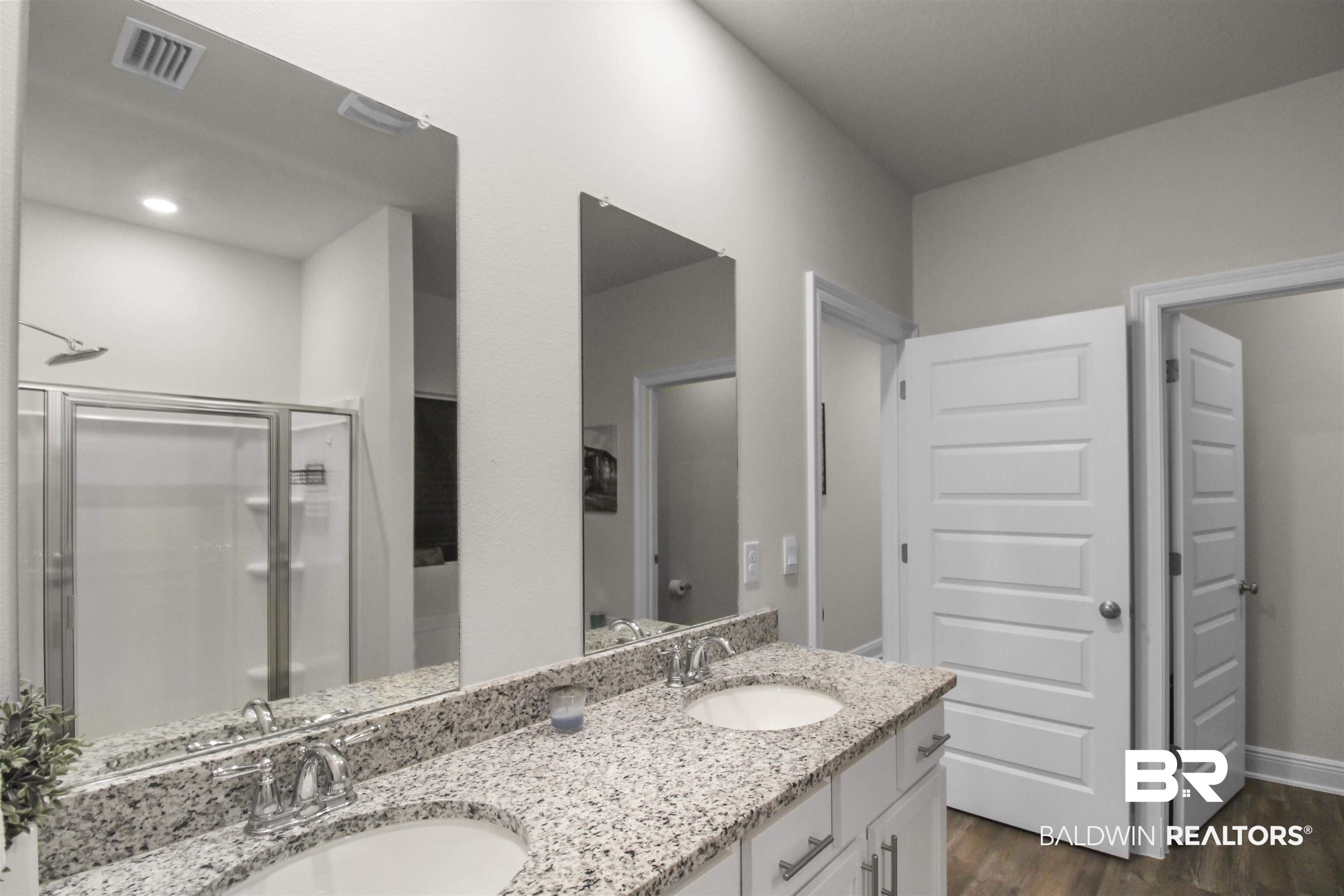 12523 Pheasant Run Elberta, AL 36530 - Photo 22 of 43 Full bathroom with a shower stall, double vanity, and dark wood-style floors