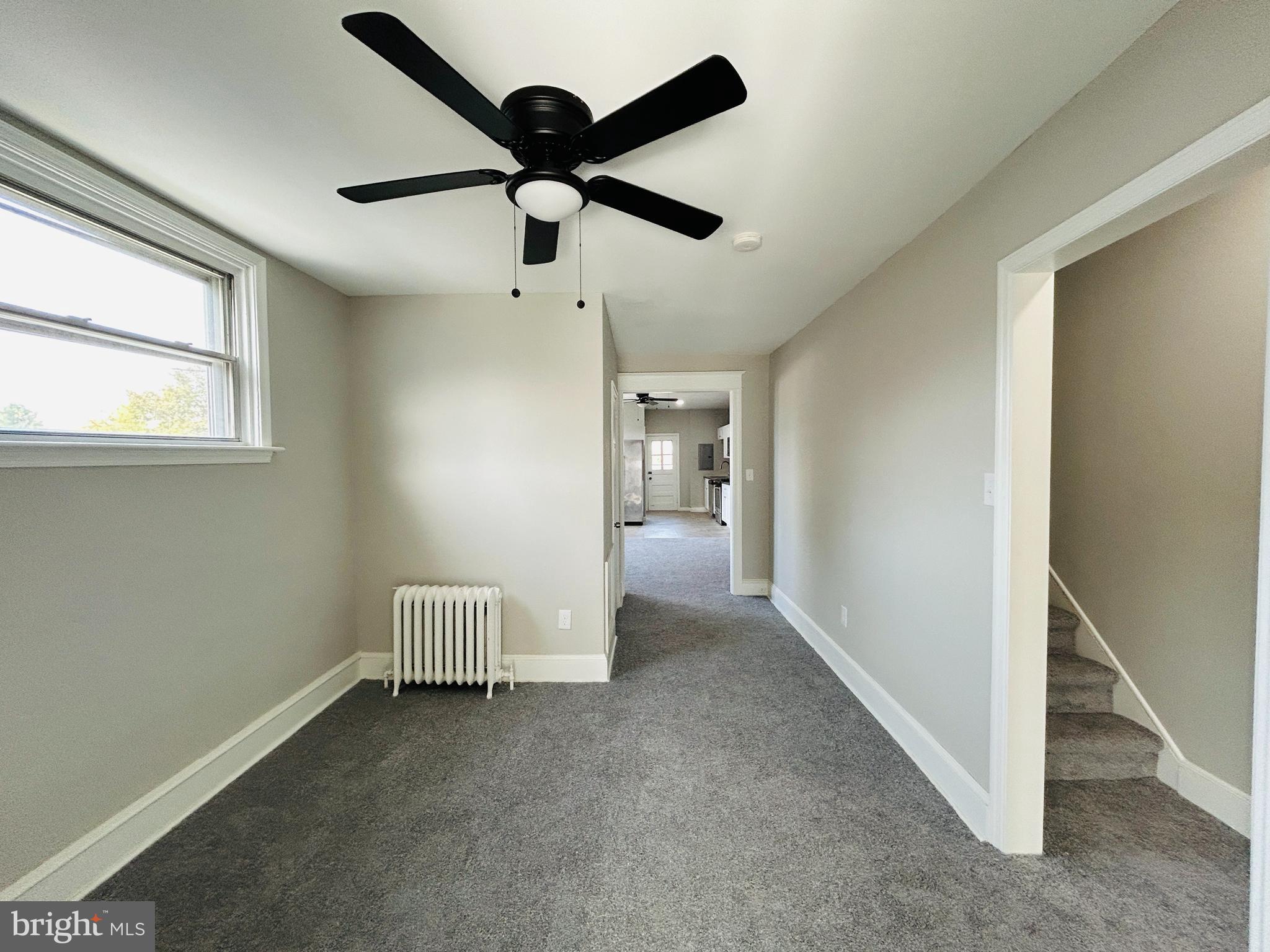 326 Fountain Street Philadelphia, PA 19128 - Photo 11 of 24 an empty room with a ceiling fan and a window