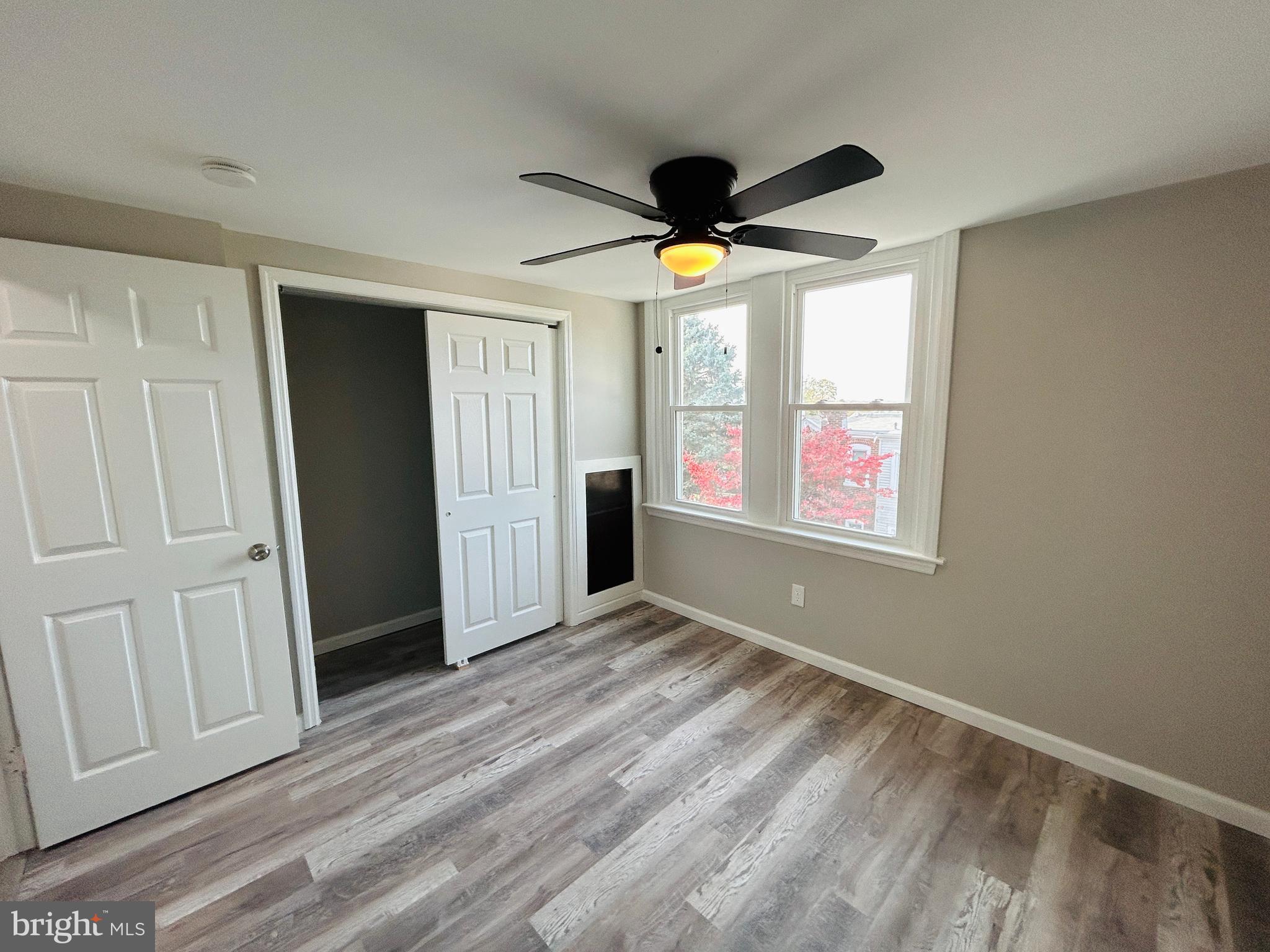 326 Fountain Street Philadelphia, PA 19128 - Photo 20 of 24 an empty room with windows and a ceiling fan