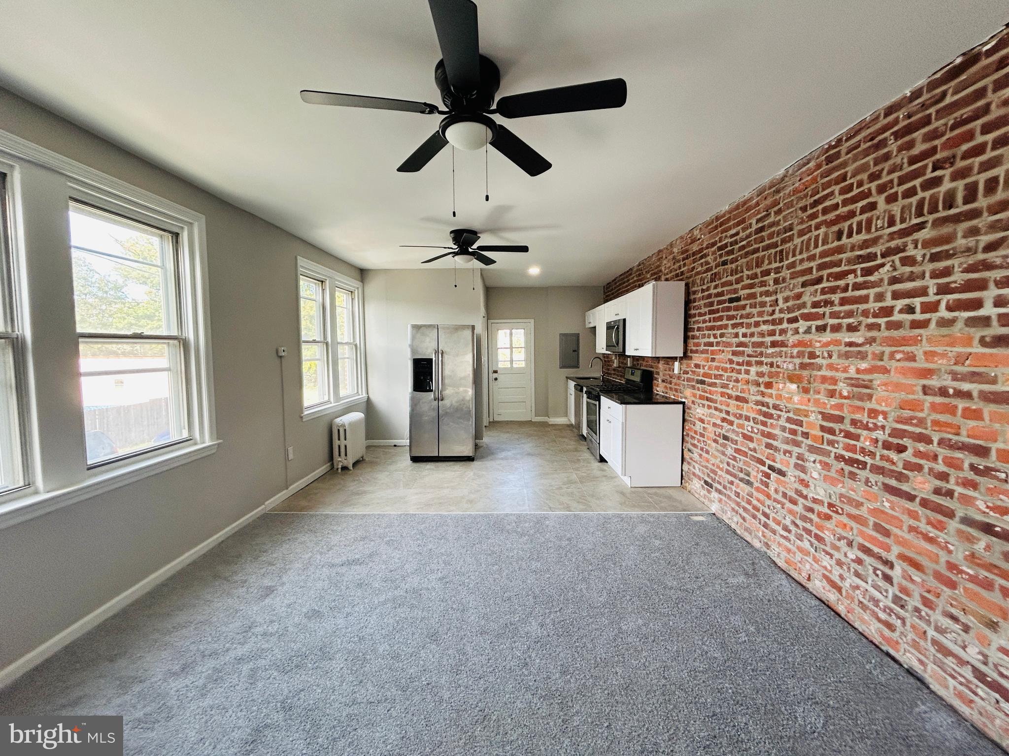 326 Fountain Street Philadelphia, PA 19128 - Photo 6 of 24 a view of empty room with a ceiling fan and window