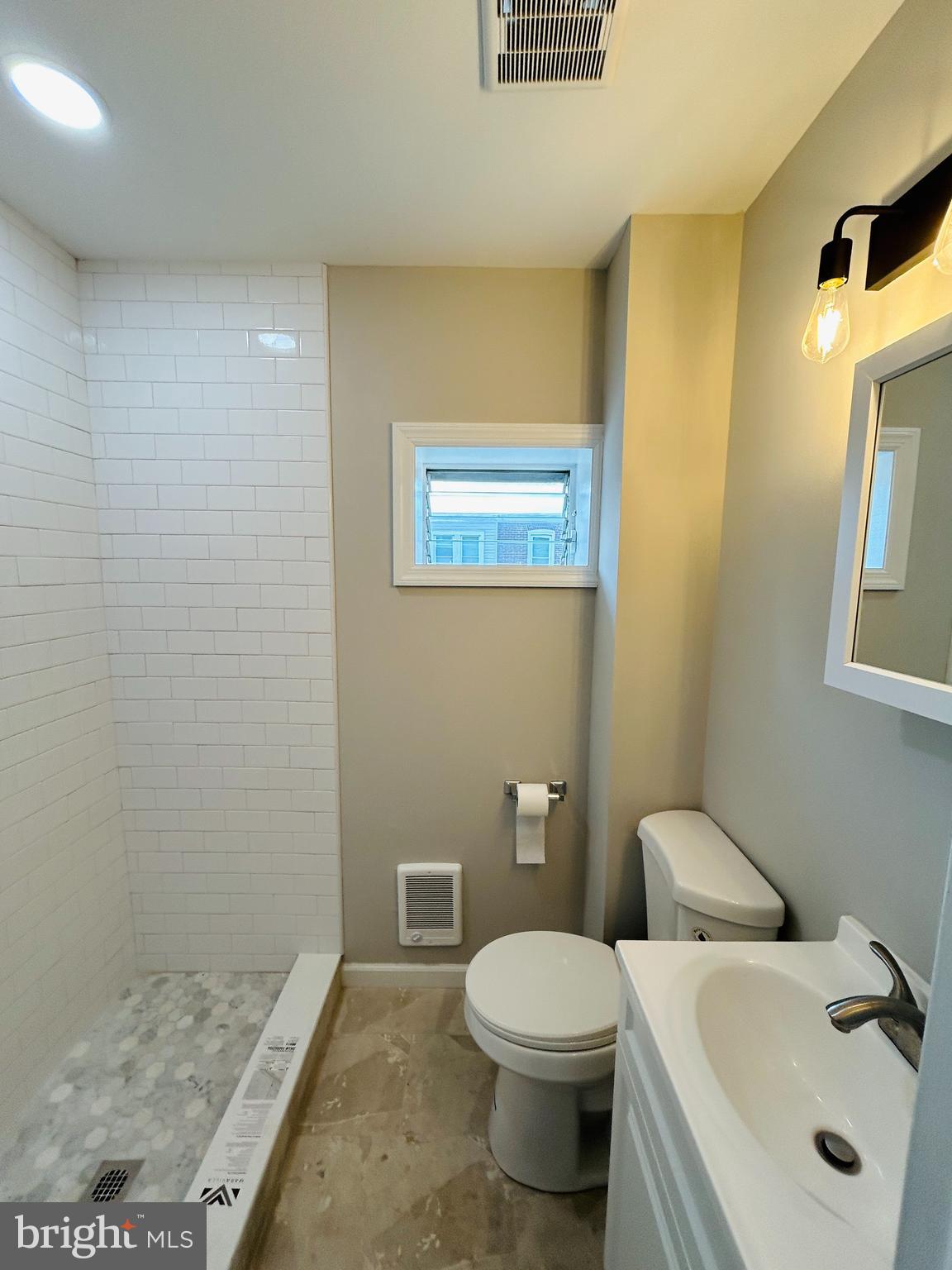 326 Fountain Street Philadelphia, PA 19128 - Photo 10 of 24 a bathroom with a sink a toilet and mirror