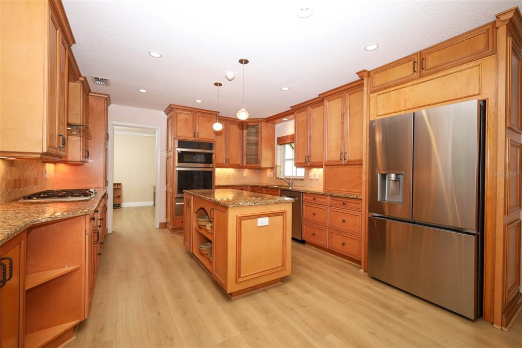 102 Pineview Court Altamonte Springs, FL 32714 - Photo 12 of 59 a kitchen with stainless steel appliances granite countertop a refrigerator a stove a sink and a microwave